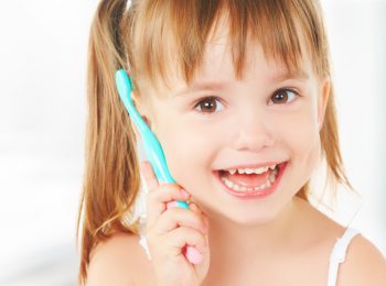 dental hygiene. happy little girl brushing her teeth